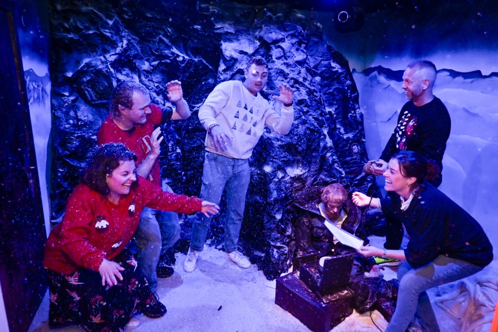 A staff Christmas party laughing in a Darkmaster escape room