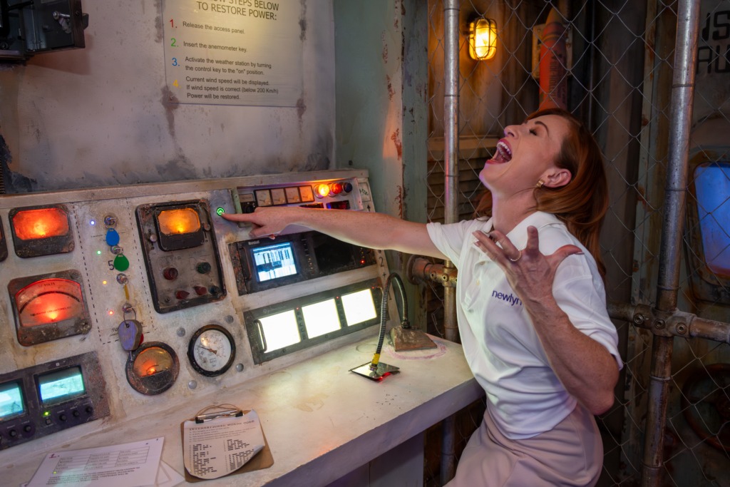 A woman screams pressing a button in an escape room